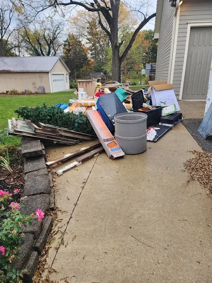 Dumpster being loaded with debris for Residential Dumpster Rental in Wintersville